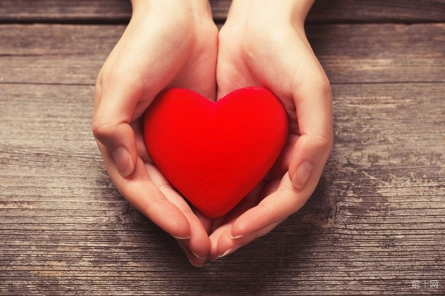 Female hands giving red heart